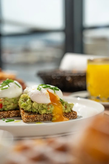 Avocado toast with poached egg and fresh juice.