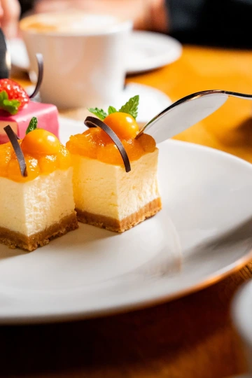 Mini cheesecakes with fruit on a plate.