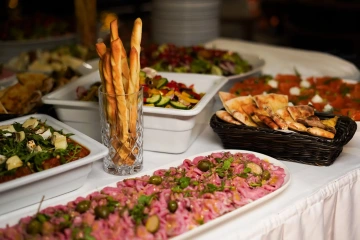 Buffet spread with baguettes, tartare and antipasti for events and celebrations.