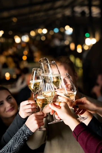 Group toasting with sparkling wine at a celebration in Marina Ristorante.